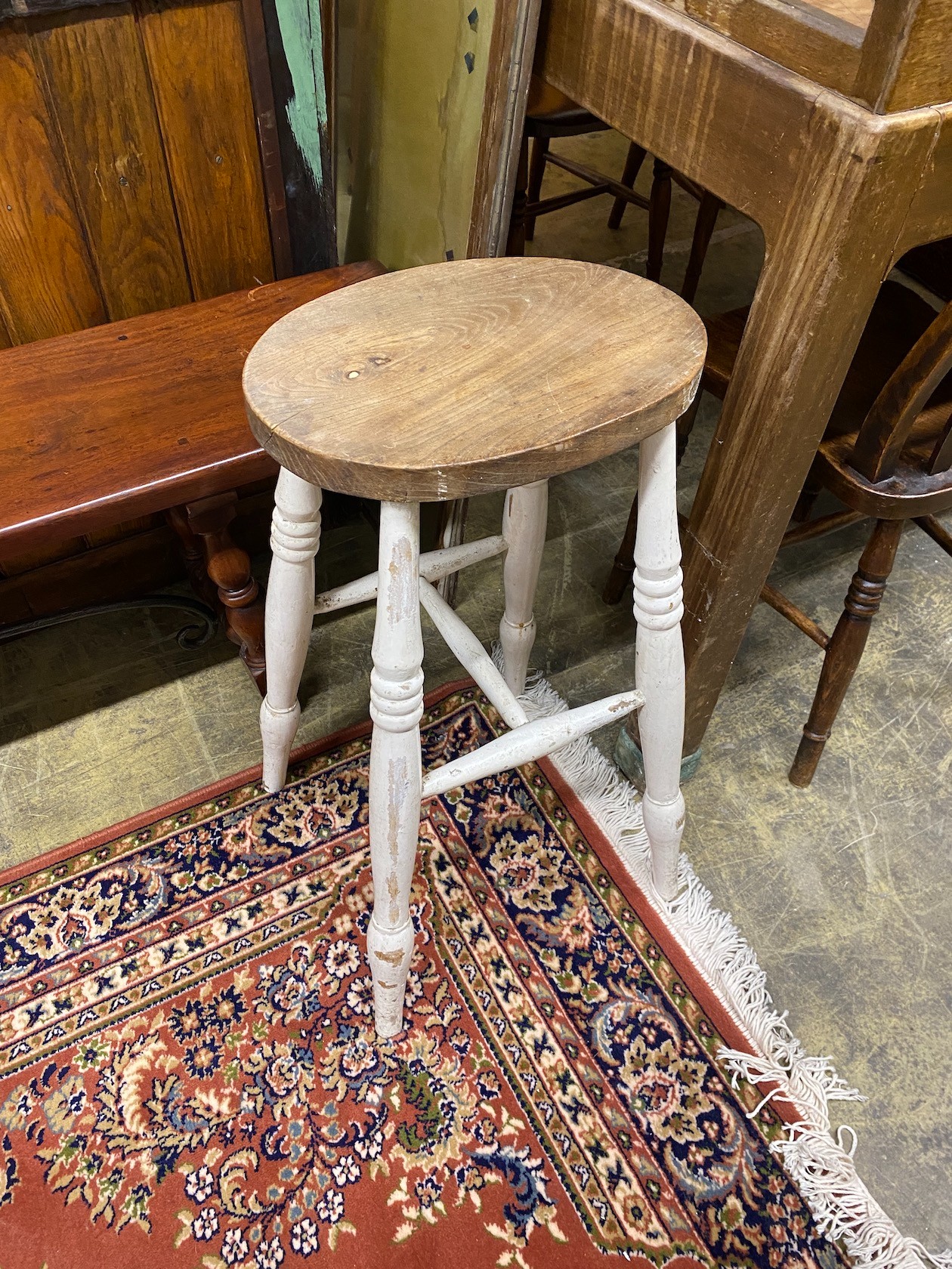 A set of six Victorian elm and beech Windsor lathe back kitchen chairs together with a circular part painted elm stool